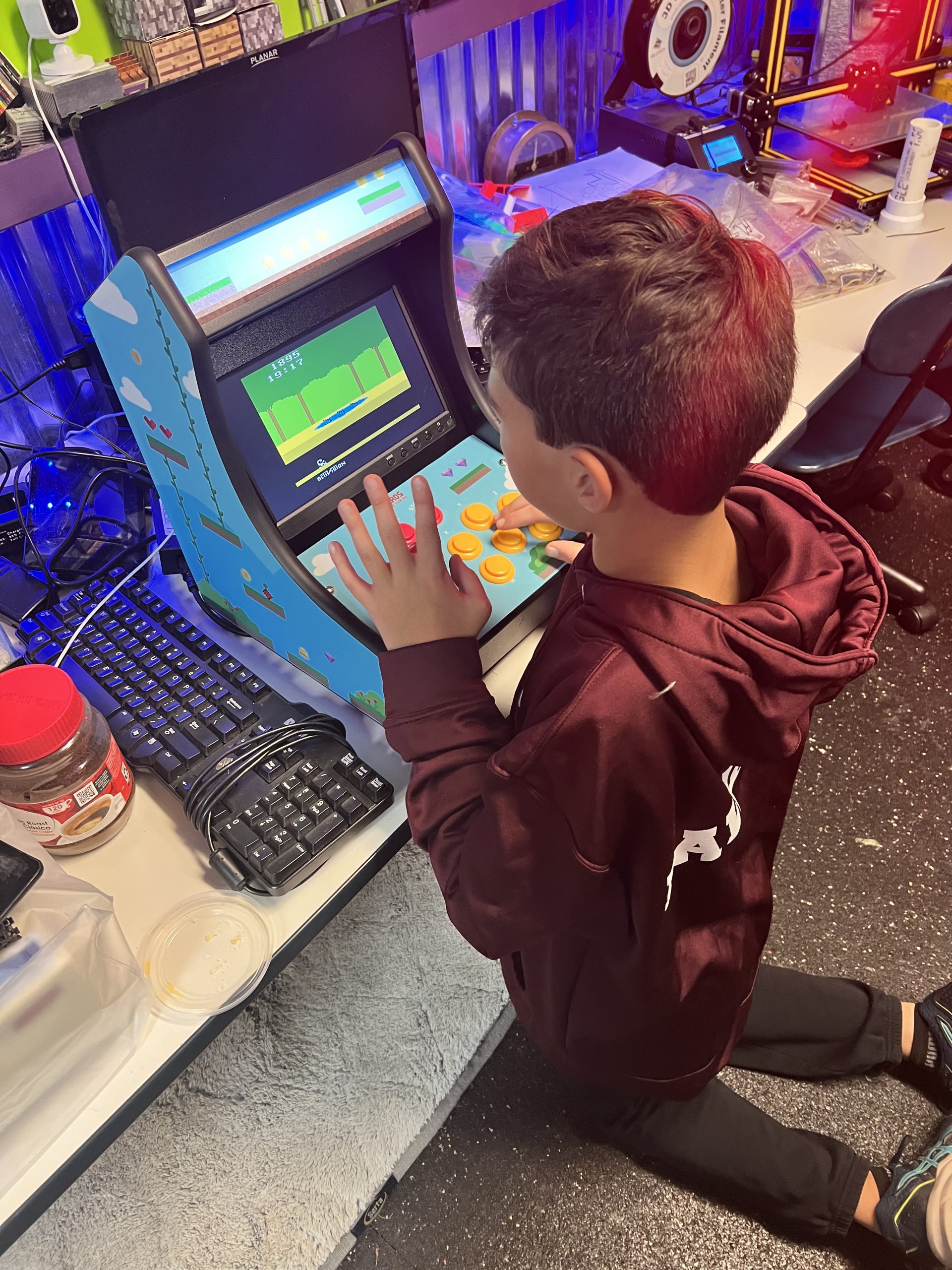 Student playing retro game on Raspberry Pi arcade cabinet at Plum Crazy Robotics Marlboro NJ