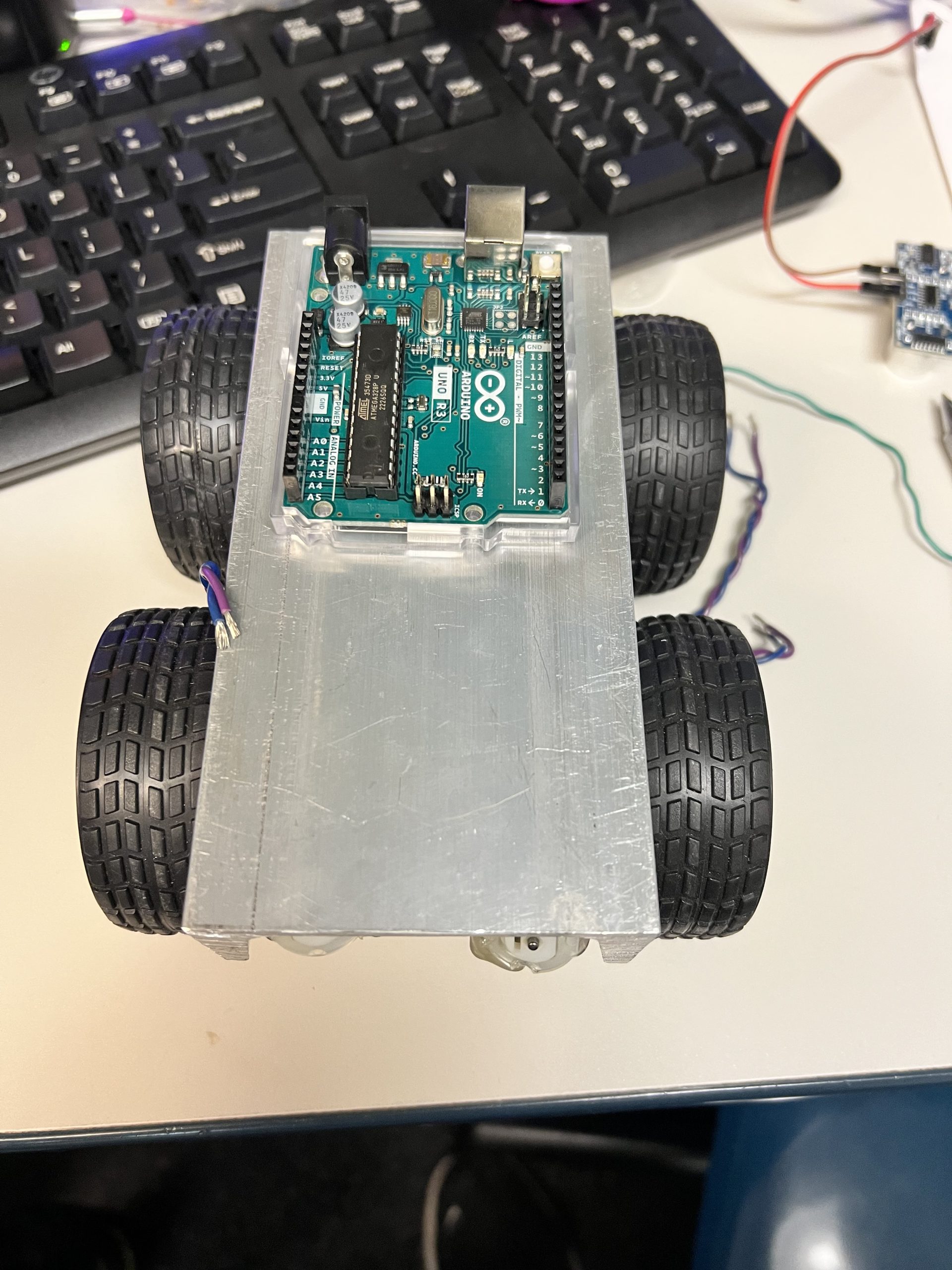 Arduino Uno R3 mounted on aluminum 4WD robot chassis built at Plum Crazy Robotics class