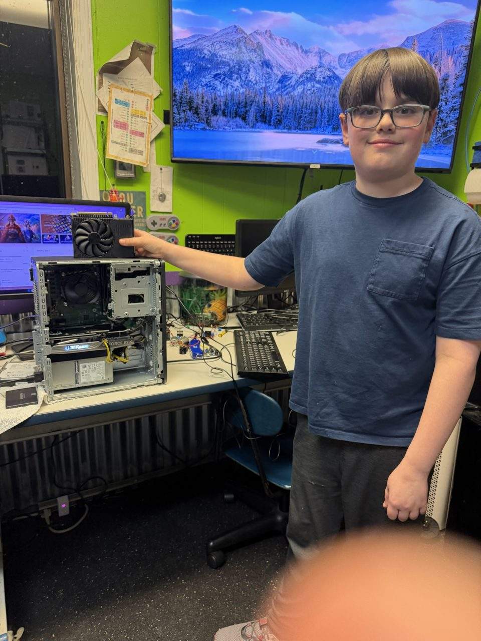 Student installing GPU graphics card into desktop computer at Plum Crazy Robotics Marlboro NJ